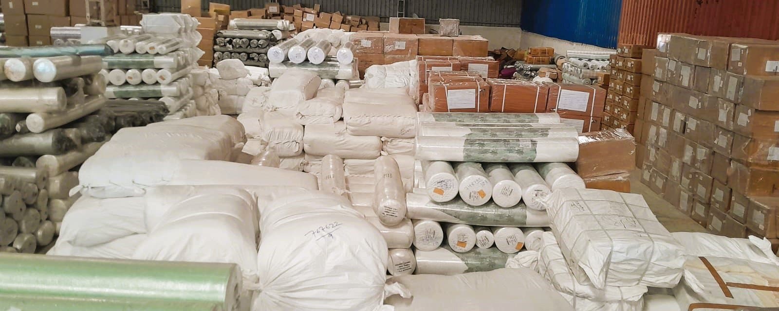 Textile rolls and cartons stored inside a Flywing warehouse